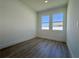 Bedroom featuring luxury vinyl flooring, two windows, and plenty of natural light at 4295 Nw 1St Court Rd, Ocala, FL 34475