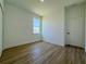 Bright bedroom featuring wood floors, a window, and white walls at 4295 Nw 1St Court Rd, Ocala, FL 34475
