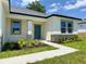 View of front entrance with a turquoise front door and decorative stone accents at 4295 Nw 1St Court Rd, Ocala, FL 34475