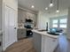 Kitchen island with stainless steel sink, pendant lighting, and gray cabinetry at 4295 Nw 1St Court Rd, Ocala, FL 34475