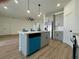 Bright kitchen with island, sleek gray cabinets, and stainless steel refrigerator at 4295 Nw 1St Court Rd, Ocala, FL 34475