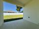 Covered lanai with a view of the green lawn and fenced backyard at 4295 Nw 1St Court Rd, Ocala, FL 34475