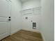 A clean laundry room with laminate floors and a wire shelf at 4295 Nw 1St Court Rd, Ocala, FL 34475