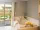 Relaxing bathroom featuring a soaking tub with candles and views of a private garden at 490 Burnt Tree Ln, Apopka, FL 32712