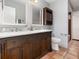 Bathroom with double vanity, dark wood cabinets, and ceramic tile floors at 490 Burnt Tree Ln, Apopka, FL 32712
