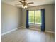 Bedroom with new light-colored floors, a ceiling fan, and window with green view at 490 Burnt Tree Ln, Apopka, FL 32712