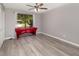 Bedroom with new light-colored floors, a ceiling fan, and large window at 490 Burnt Tree Ln, Apopka, FL 32712