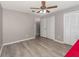 Bedroom with new light-colored floors, ceiling fan, and walk-in closets at 490 Burnt Tree Ln, Apopka, FL 32712