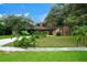 Charming single-story home with lush landscaping and a well-manicured lawn at 490 Burnt Tree Ln, Apopka, FL 32712