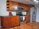 Kitchen with custom cabinets and stainless steel appliances at 490 Burnt Tree Ln, Apopka, FL 32712