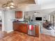 Well-appointed kitchen with wooden cabinetry, stainless steel appliances, and seamless flow to the living area at 490 Burnt Tree Ln, Apopka, FL 32712
