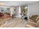 Spacious living room featuring modern floors, large windows, and seamless transition to adjacent rooms at 490 Burnt Tree Ln, Apopka, FL 32712