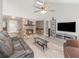 Spacious living room with stone fireplace, vaulted ceilings, and modern furnishings creating a comfortable atmosphere at 490 Burnt Tree Ln, Apopka, FL 32712