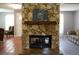 Living room stone fireplace with hardwood mantle and tiled hearth at 490 Burnt Tree Ln, Apopka, FL 32712