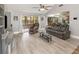 Open-concept living room with modern floors, a comfortable sofa, and seamless transition to outdoor spaces at 490 Burnt Tree Ln, Apopka, FL 32712