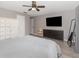Spacious main bedroom with a ceiling fan, TV, and light gray walls at 490 Burnt Tree Ln, Apopka, FL 32712