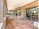 Enclosed patio with tiled floors, multiple ceiling fans, and views of the backyard at 490 Burnt Tree Ln, Apopka, FL 32712