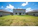 A backyard featuring a manicured lawn between neighboring homes at 5553 Turkey Creek Way, Lakeland, FL 33811