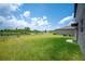 Expansive backyard with lush green grass and a serene view of the lake at 5553 Turkey Creek Way, Lakeland, FL 33811