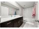 Bathroom with a vanity, a sink, and a shower-tub with a white curtain at 5553 Turkey Creek Way, Lakeland, FL 33811