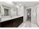 Bright bathroom features a double sink vanity with dark wood cabinets and white countertops at 5553 Turkey Creek Way, Lakeland, FL 33811