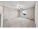 Neutral bedroom features soft carpet, a ceiling fan, and a window offering natural light at 5553 Turkey Creek Way, Lakeland, FL 33811