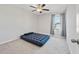 Bedroom with carpeted floor and a window with gray curtains lets in natural light at 5553 Turkey Creek Way, Lakeland, FL 33811