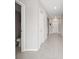 Hallway with tile floors leads past a half-bath and closet to the front door at 5553 Turkey Creek Way, Lakeland, FL 33811