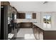 Modern kitchen featuring dark cabinets, white countertops, stainless steel appliances, and a large island at 5553 Turkey Creek Way, Lakeland, FL 33811