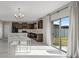 Open dining and kitchen area with dark wood cabinets, stainless steel appliances, and lots of natural light at 5553 Turkey Creek Way, Lakeland, FL 33811