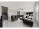 Spacious living room with tile floors, a large gray sectional sofa, and easy access to the kitchen at 5553 Turkey Creek Way, Lakeland, FL 33811