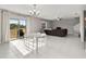 Bright living room with tile floors, a modern chandelier, and sliding glass doors to the backyard at 5553 Turkey Creek Way, Lakeland, FL 33811