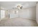 Upstairs loft space features neutral walls, carpet flooring, ceiling fan, and a window at 5553 Turkey Creek Way, Lakeland, FL 33811