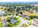 An aerial view shows the property's location in a neighborhood with mature trees, a pond, and well-maintained lawns at 8023 Canyon Lake Cir, Orlando, FL 32835