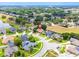 An aerial view shows the property's location in a neighborhood with mature trees, a pond, and well-maintained lawns at 8023 Canyon Lake Cir, Orlando, FL 32835