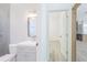 Bathroom with modern fixtures, tiled shower, gray vanity, and an open doorway at 8023 Canyon Lake Cir, Orlando, FL 32835