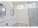 Modern bathroom featuring double sinks, stylish mirrors, and a glass-enclosed shower at 8023 Canyon Lake Cir, Orlando, FL 32835