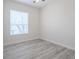 Bright bedroom with a large window offering ample natural light, and stylish flooring at 8023 Canyon Lake Cir, Orlando, FL 32835