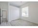 Bright bedroom featuring a large window, closet, and neutral color palette at 8023 Canyon Lake Cir, Orlando, FL 32835