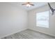 Well-lit bedroom with a ceiling fan, large window, and stylish flooring at 8023 Canyon Lake Cir, Orlando, FL 32835