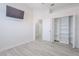 Spacious bedroom with a TV, closet with shelving, and light gray wood floors at 8023 Canyon Lake Cir, Orlando, FL 32835