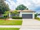A well-maintained lawn, mature trees, and a paved driveway enhance the curb appeal of this beautiful home at 8023 Canyon Lake Cir, Orlando, FL 32835