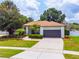 Beautiful single-Gathering home with a well-manicured lawn, mature trees, and a large driveway at 8023 Canyon Lake Cir, Orlando, FL 32835