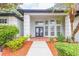 Inviting front entrance with double doors, decorative columns, and manicured landscaping at 8023 Canyon Lake Cir, Orlando, FL 32835