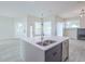 Open floorplan view features a large kitchen island with sink and stylish pendant lighting at 8023 Canyon Lake Cir, Orlando, FL 32835