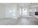 Bright open-concept living room with modern lighting, hardwood floors, and backyard views at 8023 Canyon Lake Cir, Orlando, FL 32835