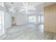 Bright open-concept living room with modern lighting, hardwood floors, and large windows at 8023 Canyon Lake Cir, Orlando, FL 32835