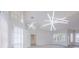 Bright open-concept living room with modern lighting, hardwood floors, and large windows at 8023 Canyon Lake Cir, Orlando, FL 32835