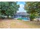 Aerial view of pool with screened enclosure, set in a peaceful, tree-lined backyard at 8023 Canyon Lake Cir, Orlando, FL 32835