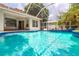 Sparkling pool with patio, surrounded by a screen enclosure and lush landscaping at 8023 Canyon Lake Cir, Orlando, FL 32835